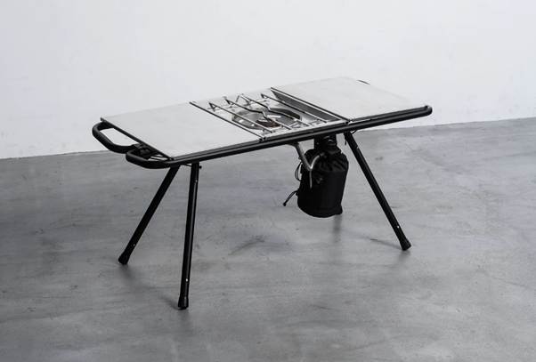 A table with a black bag on it

AI-generated content may be incorrect.