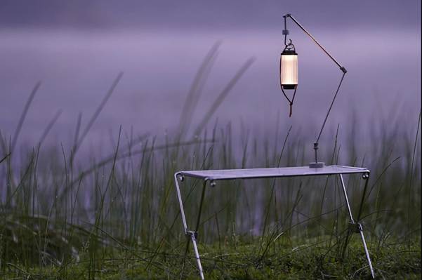 A table and lamp in a field

AI-generated content may be incorrect.
