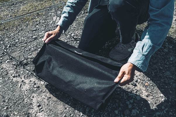 A person holding a black bag

AI-generated content may be incorrect.