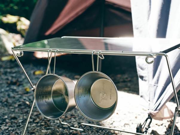 A metal pot rack with two cups from it

AI-generated content may be incorrect.