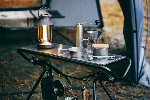 A table with a lantern and pots on it

AI-generated content may be incorrect.