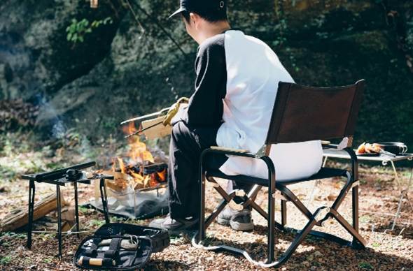 A person sitting in a chair by a campfire

AI-generated content may be incorrect.