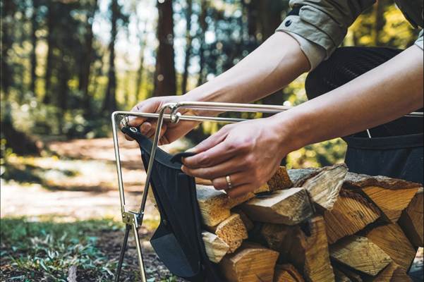A person putting a bag into a stack of wood

AI-generated content may be incorrect.