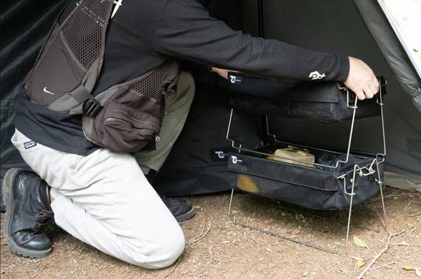 A person kneeling on the ground holding a black box

AI-generated content may be incorrect.