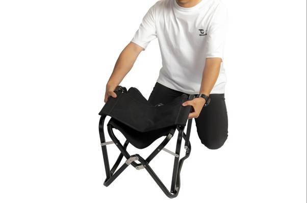 A person kneeling on his knees holding a folding chair

AI-generated content may be incorrect.