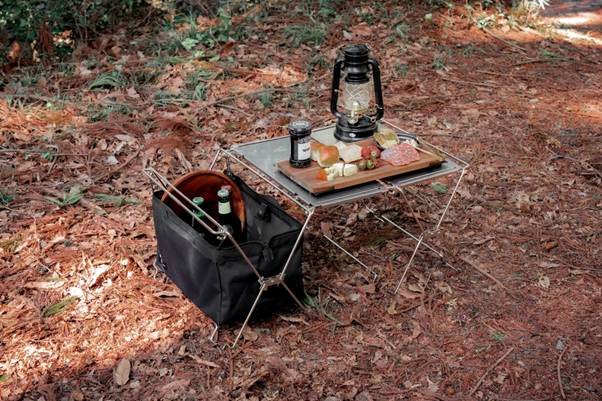 A picnic table with food and a lantern on it

AI-generated content may be incorrect.