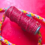 ตะกรุดเนื้อตะกั่ว ยาว1นิ้ว ถักเชือกแดง พร้อมเชื้อกคล้องคอ ไม่ทราบที่